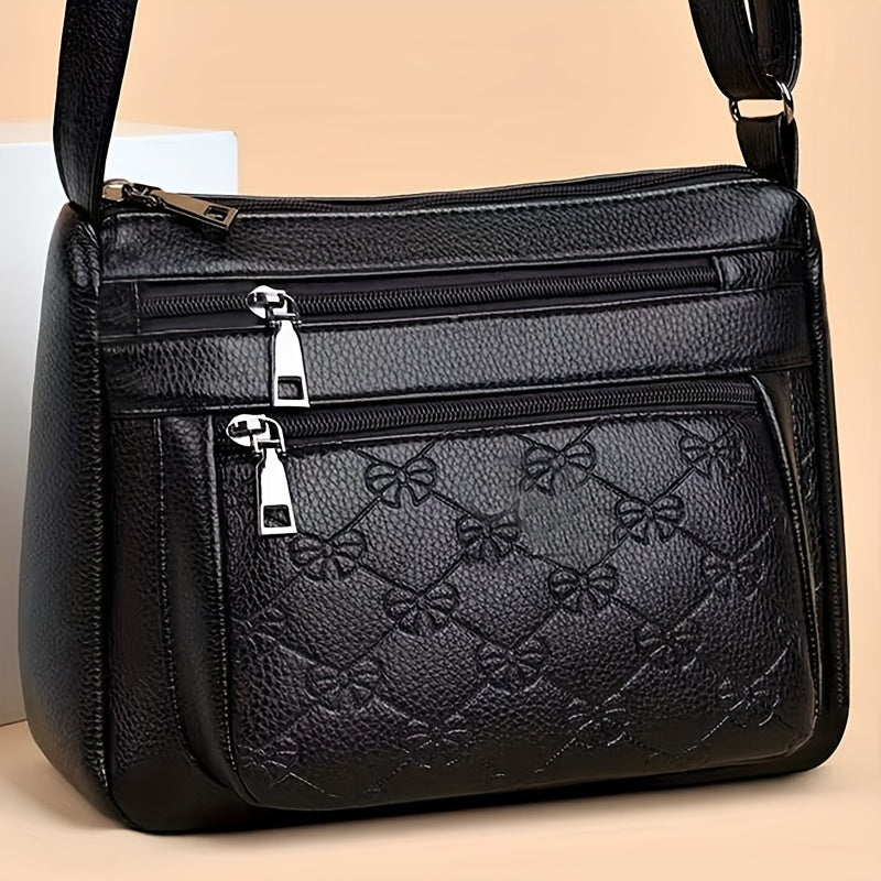 Trendy black crossbody bag for women with adjustable strap, floral design, and zipper closure, ideal for daily use.