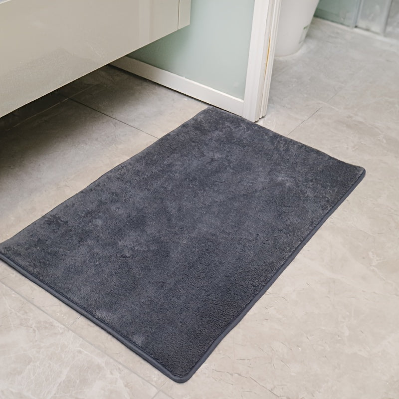 Machine-made oblong bath rug made from quick-dry absorbent knit fabric with non-slip features. Crafted from polyester fiber, this rug is 1.8cm thick and has a weight of 780gsm. Suitable for entryways, bedrooms, living rooms, and garages. Easy to care for