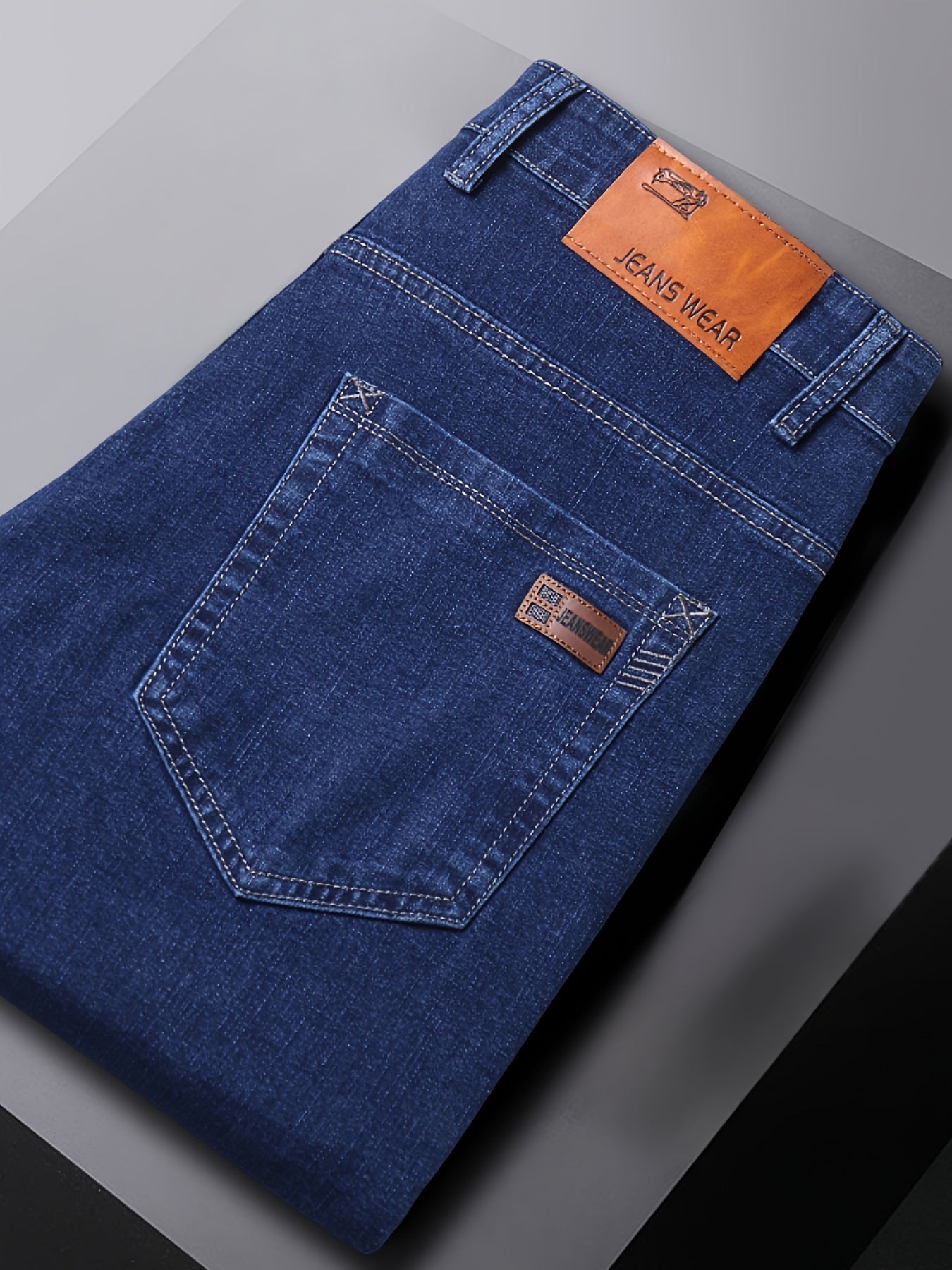 High-quality business casual denim pants for men, featuring a stretch comfort fit in a solid color washed finish. Made with all-season woven fabric of 65% cotton, 33.7% polyester, and 1.3%