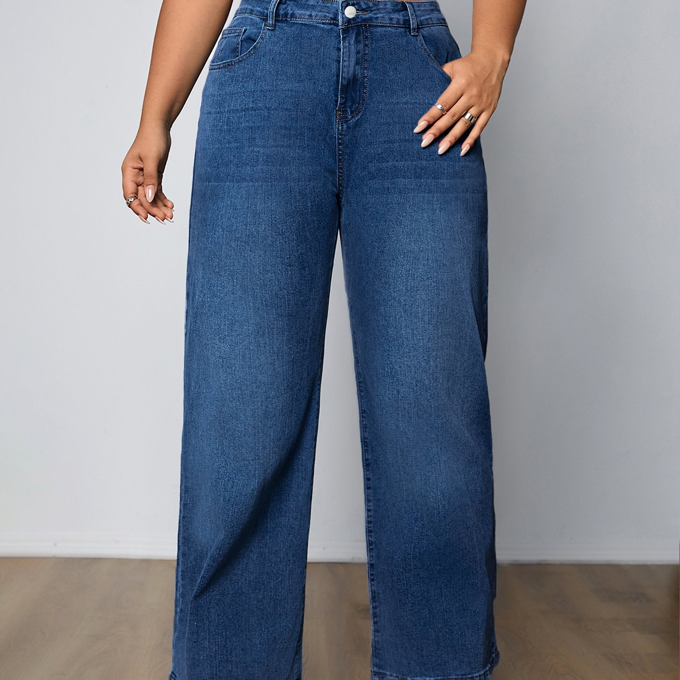 Plus size women's high-rise washed blue jeans with button fly, stretchy straight leg fit, and plain design.