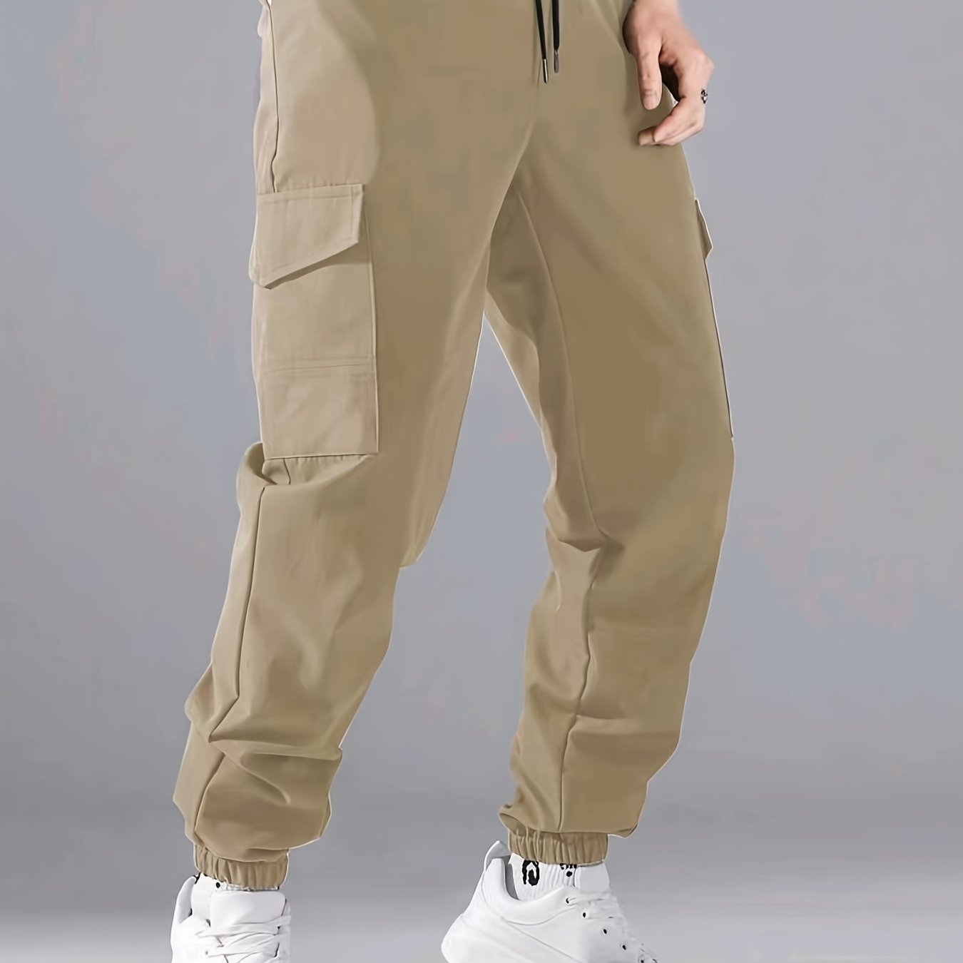 Men's casual joggers made of 100% polyester with a solid color, all-season, non-stretch fabric in a regular fit with pockets.