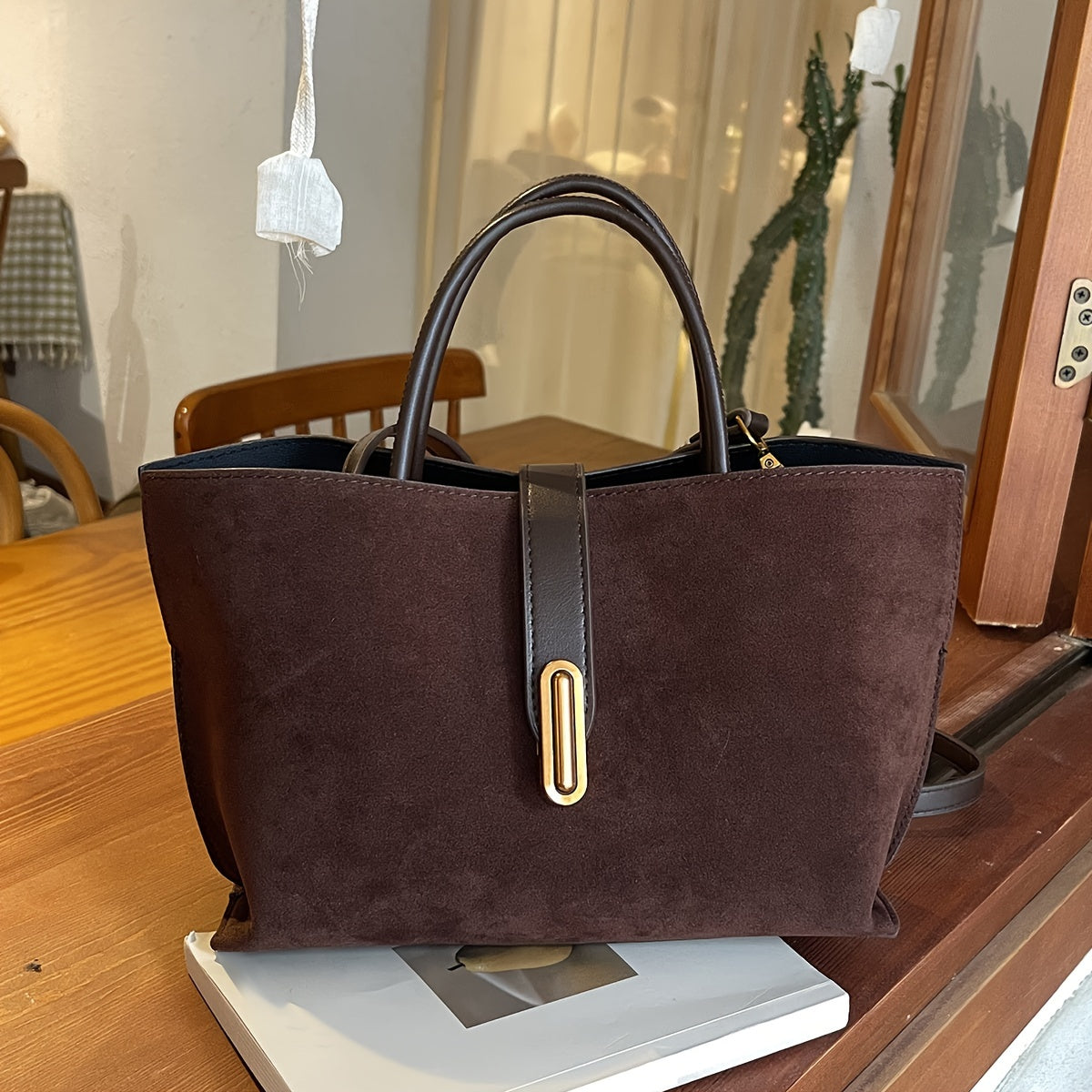 Adjustable shoulder strap tote bag with vintage style and retro large capacity, made from suede leather. Features turn lock closure and unlined fabric material.