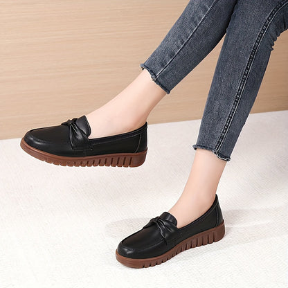 Women's comfortable penny loafers with bow embellishment, non-slip sole, round toe, all-season footwear, man-made materials, TPR sole.