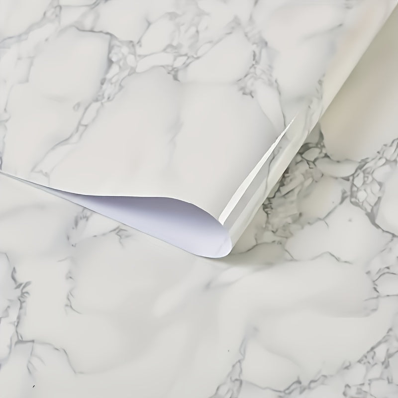 Roll of waterproof adhesive film with a marble pattern that is resistant to heat and oil. Ideal for lining kitchen and bathroom cabinets, drawers, and furniture during renovations. This non-food contact home decor solution is perfect for adding a touch