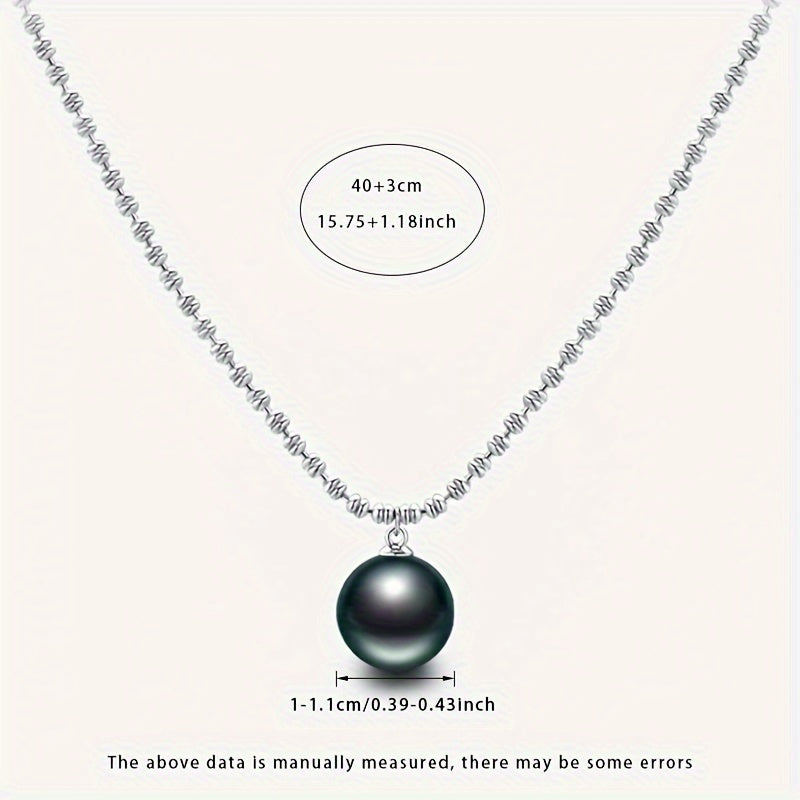 Elegant Vintage-Inspired Black Pearl Pendant Necklace for Women - Featuring Large 10-11mm Round Sea Pearls on an S925 Silver Chain. Perfect June Birthstone Gift presented in a Luxury Red Gift Box. Inspired by Polynesian design, showcasing the Natural