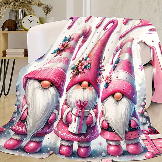 Soft, warm, and versatile flannel throw blanket featuring a cozy Christmas gnome and bell print. Perfect for snuggling on the couch, adding warmth to your office chair, staying cozy in bed, camping under the stars, or traveling in style. This all-season