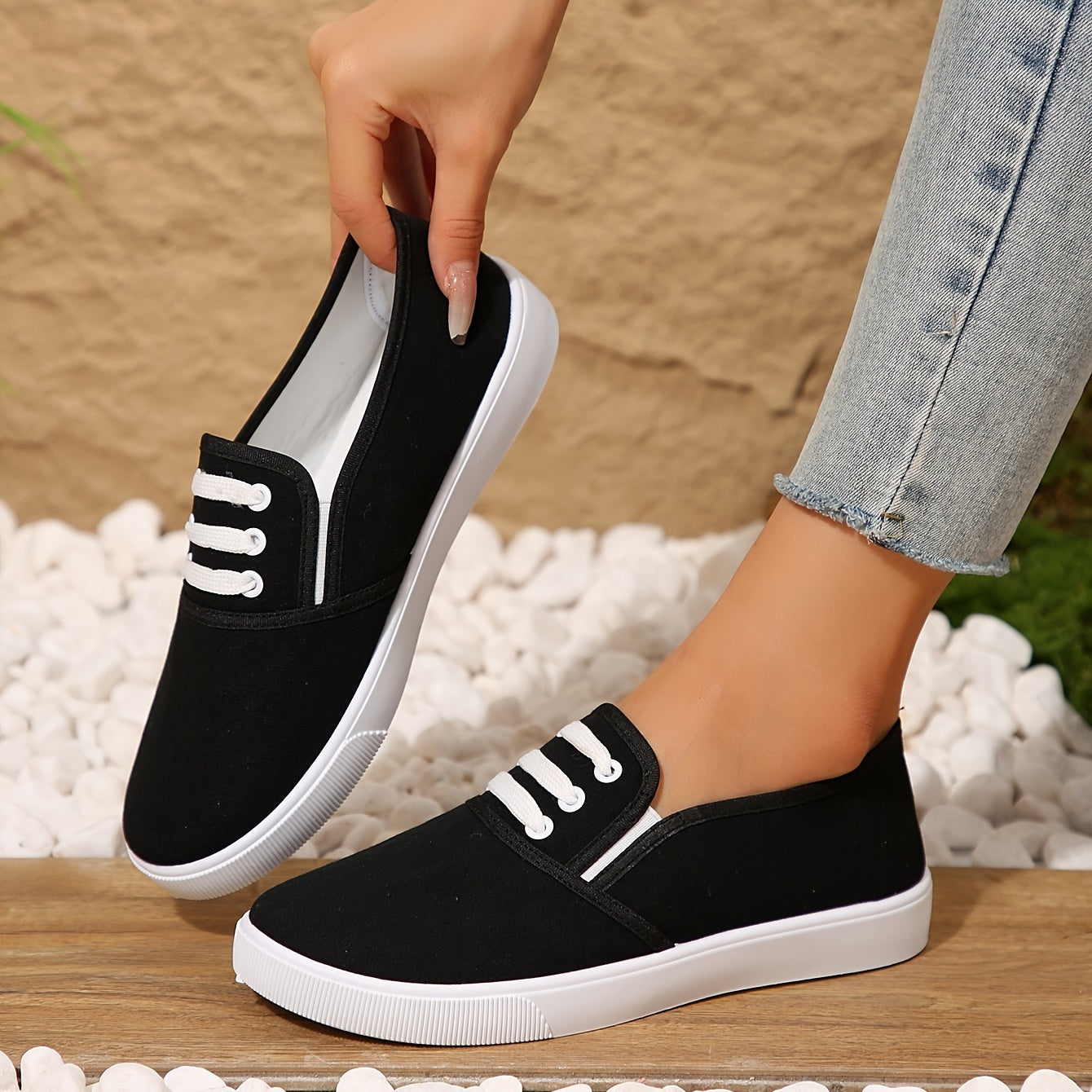 Lightweight white slip-on canvas sneakers for women with a soft sole and minimalist design.