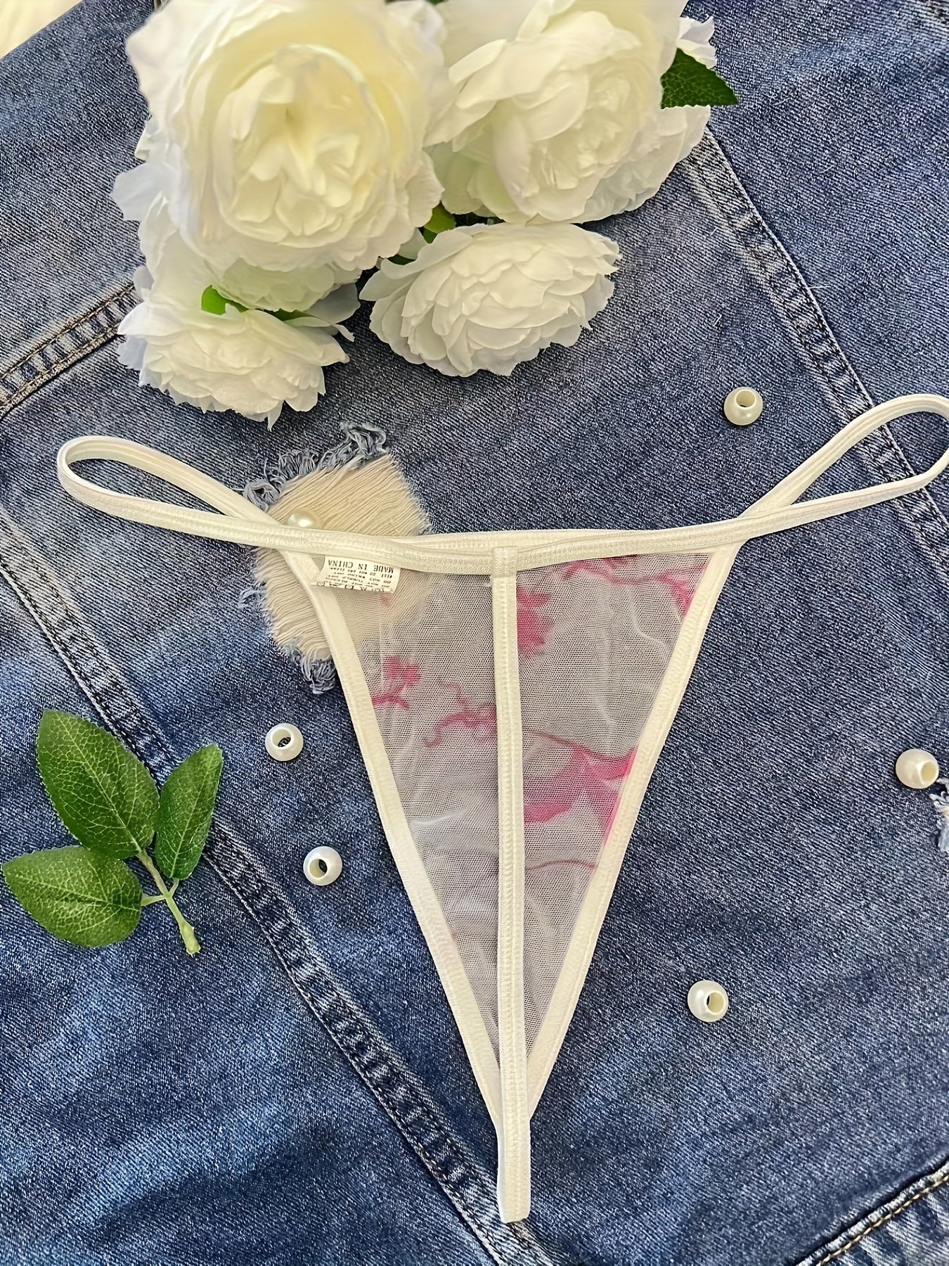 Floral print sheer thong panties made of breathable polyester and elastane blend, mid-rise and hand washable.