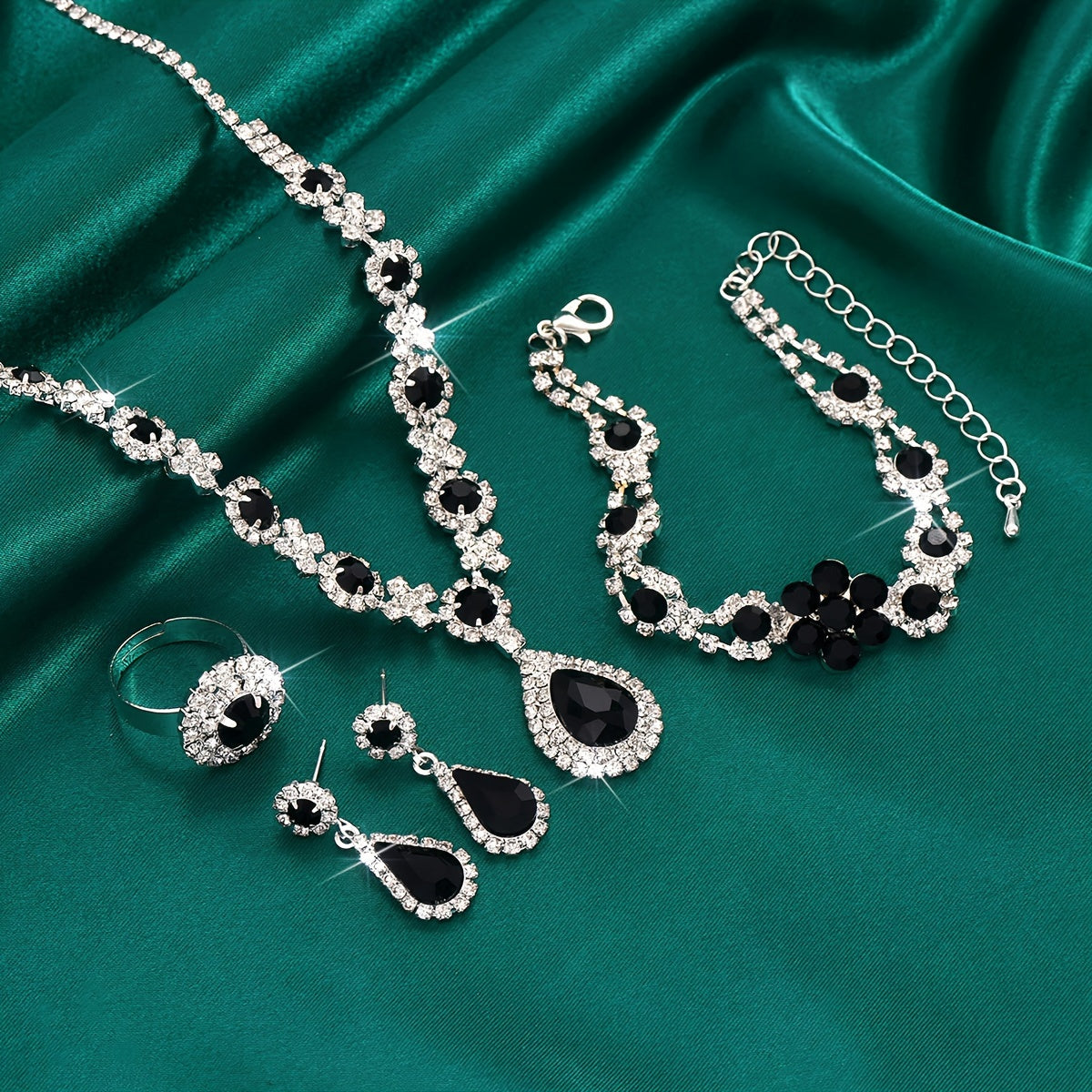 This jewelry set features a vintage 4-piece design with synthetic gemstones, a sexy tear-drop style, and a silver plated finish with rhinestones. Made from copper, this set is perfect for vacation and wedding events, and makes an ideal gift for