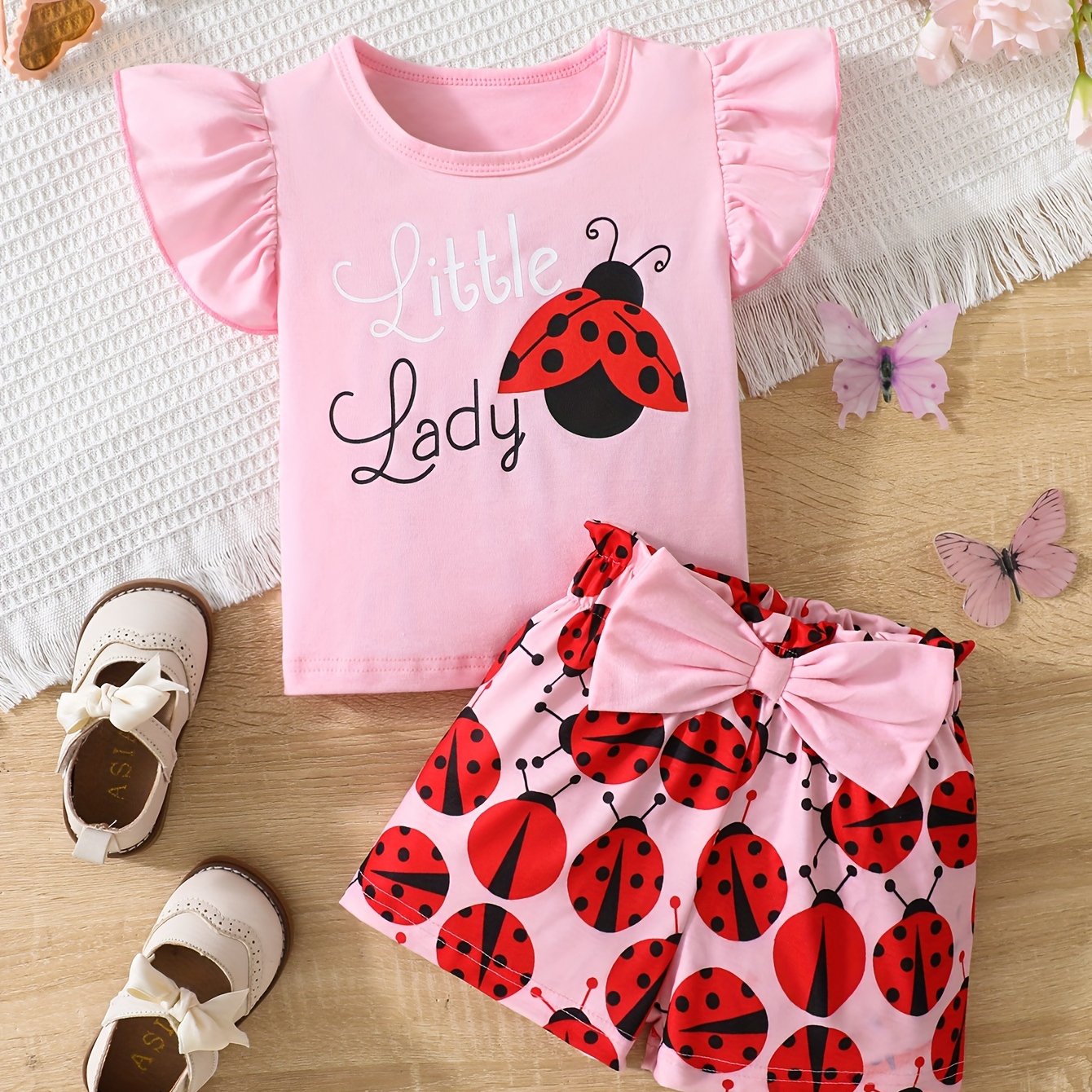 Ruffle sleeve graphic tee and ladybug shorts set for baby girl, perfect casual summer outfit.