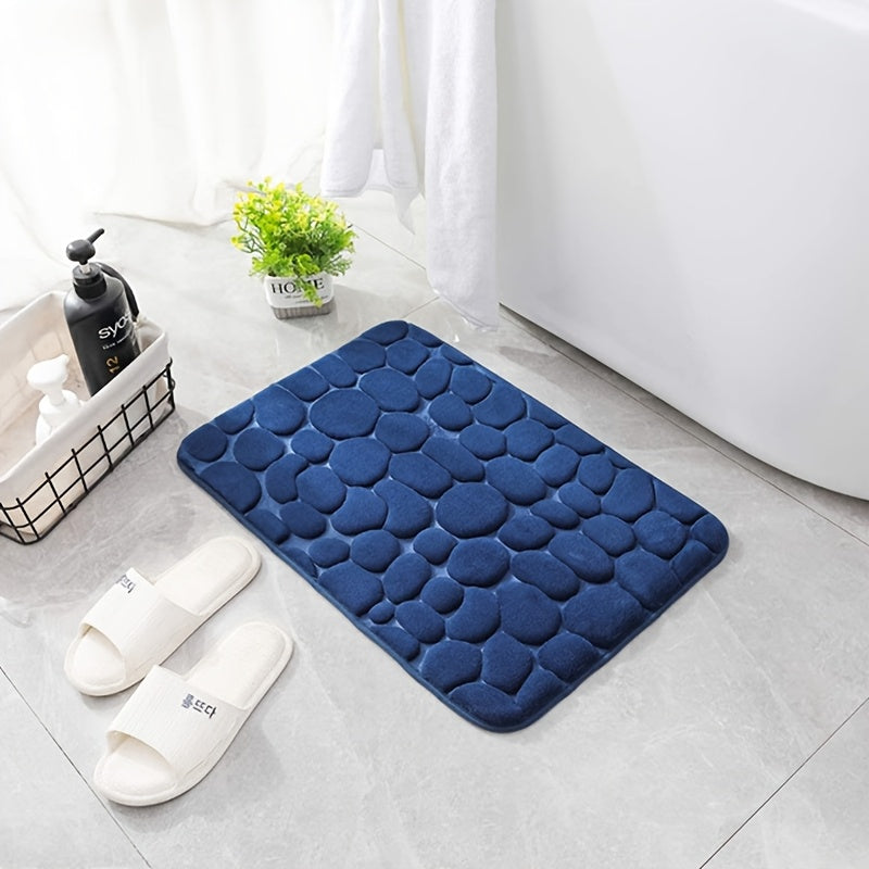 Soft and luxurious memory foam bath mat with a non-slip pebble design. This water-absorbent bathroom rug is machine washable and made of flat woven polyester with PVC backing. Featuring a low pile and solid pattern, it has non-slip capabilities for added