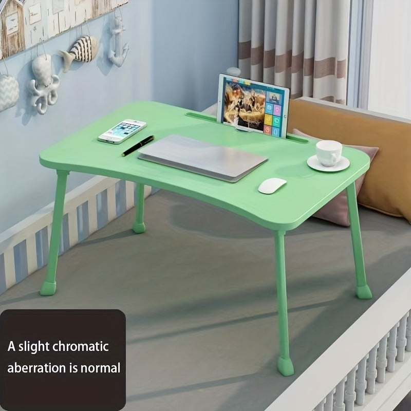 Portable laptop desk that can be used as a bed table, breakfast tray, standing desk, notebook stand, or reading holder for use on the bed, couch, sofa, or floor. Includes a convenient bottle holder and is foldable for easy storage.