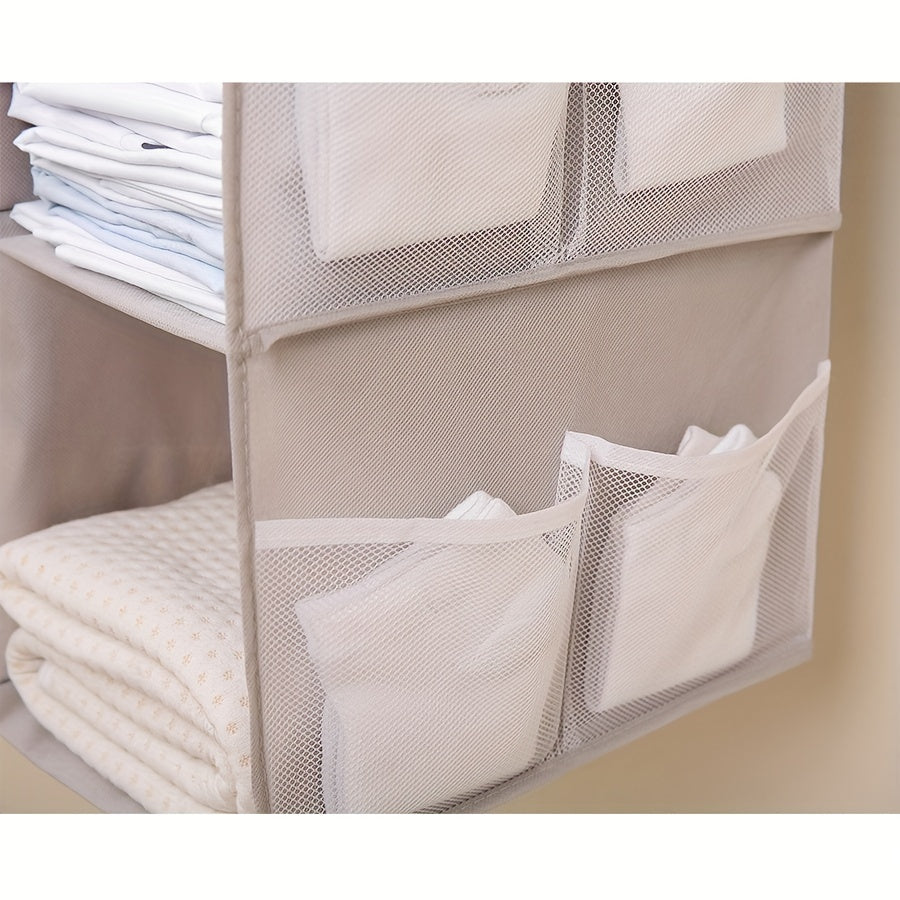 Keep your items organized and easily accessible with this Wardrobe Storage Hanging Bag. It is foldable, washable, and features four layers of storage space for bags, clothes, socks, and more. Save space and maintain neatness in your wardrobe with this