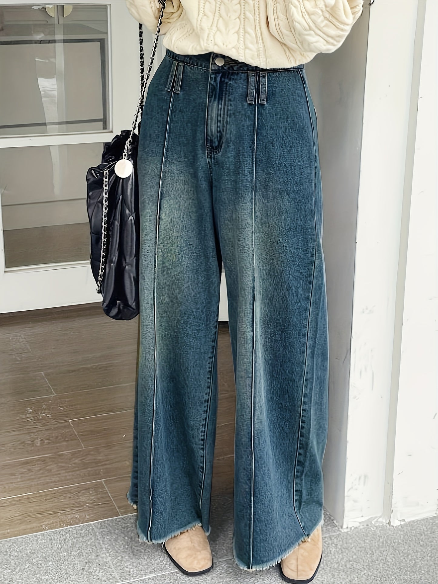 Women's wide-leg denim jeans with elastic waistband, loose fit, mid-rise, and slash pockets in light to dark blue gradient.