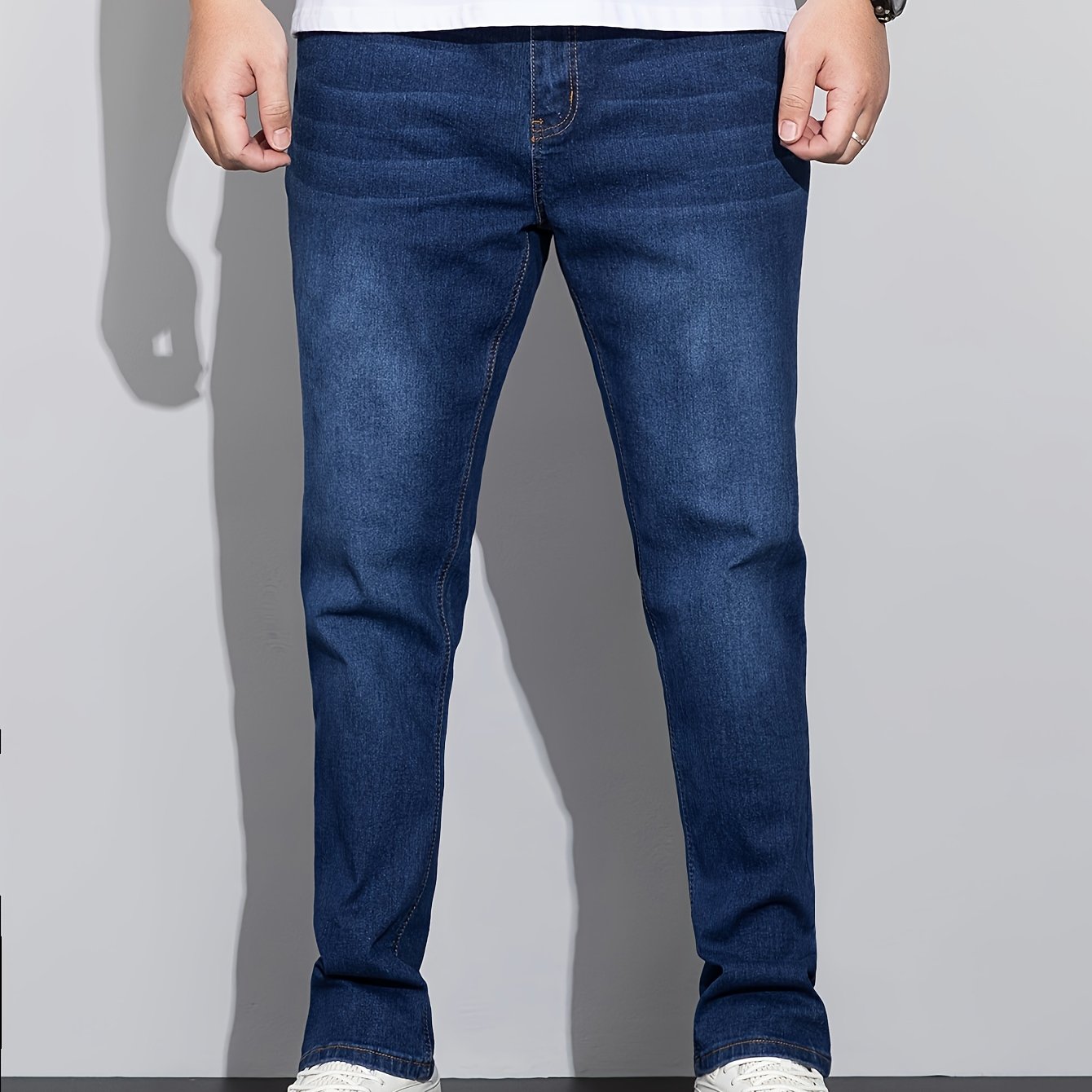 Stylish men's plus size denim pants for casual street style in spring and fall.