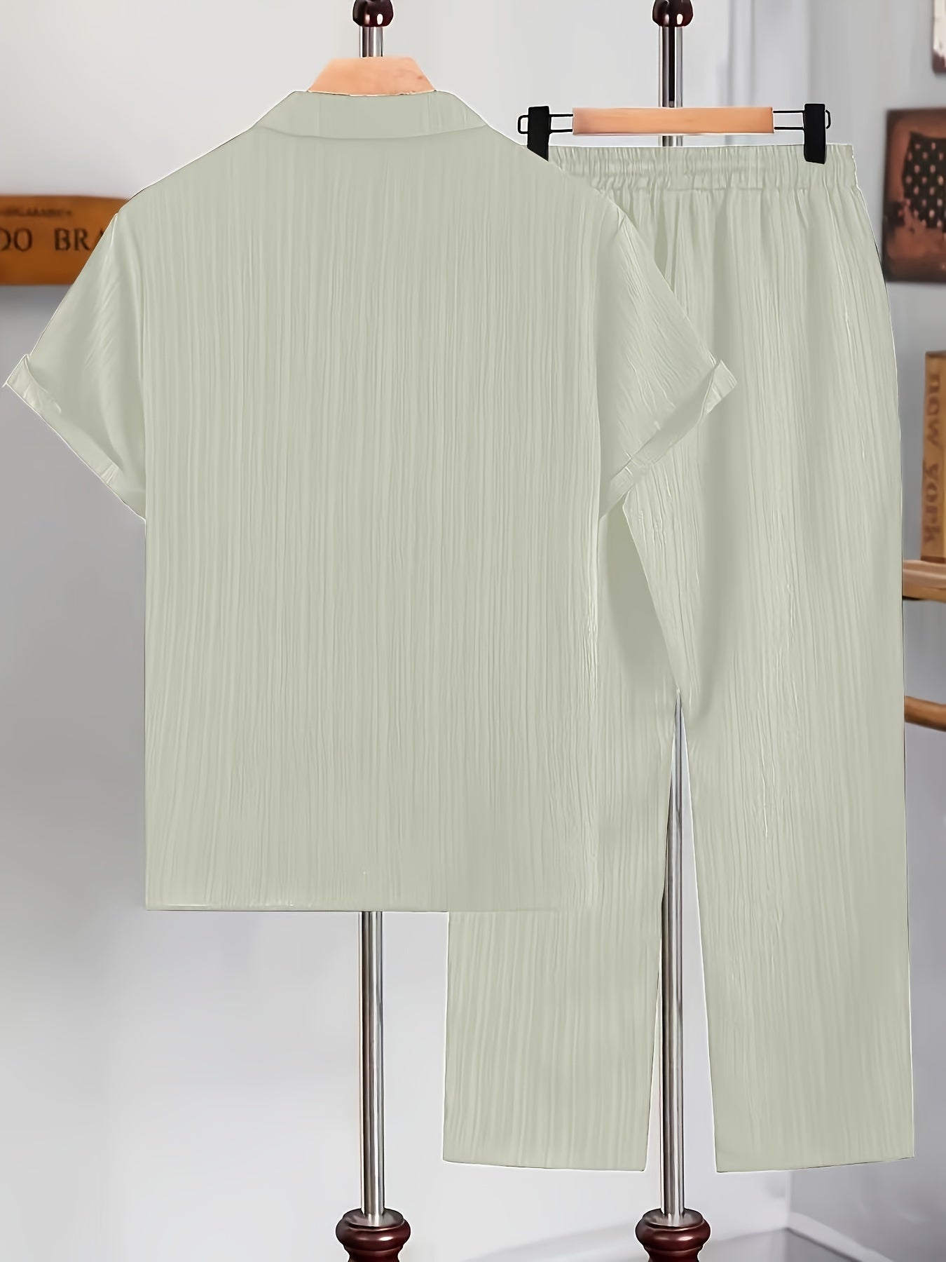 Men's casual two-piece set for summer leisure: short sleeve button-up shirt and drawstring pants.