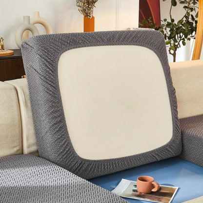 Modern gray sofa cushion cover with elastic fit and soft textured fabric. Machine washable for enhanced comfort in the living room.