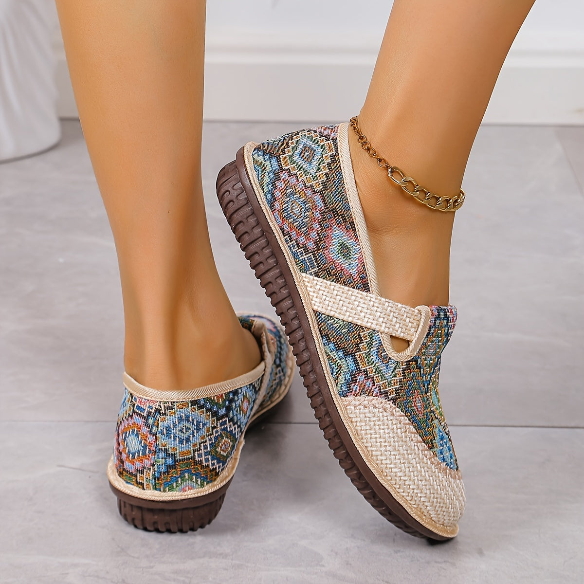 Women's printed slip-on mules with soft, lightweight soles.