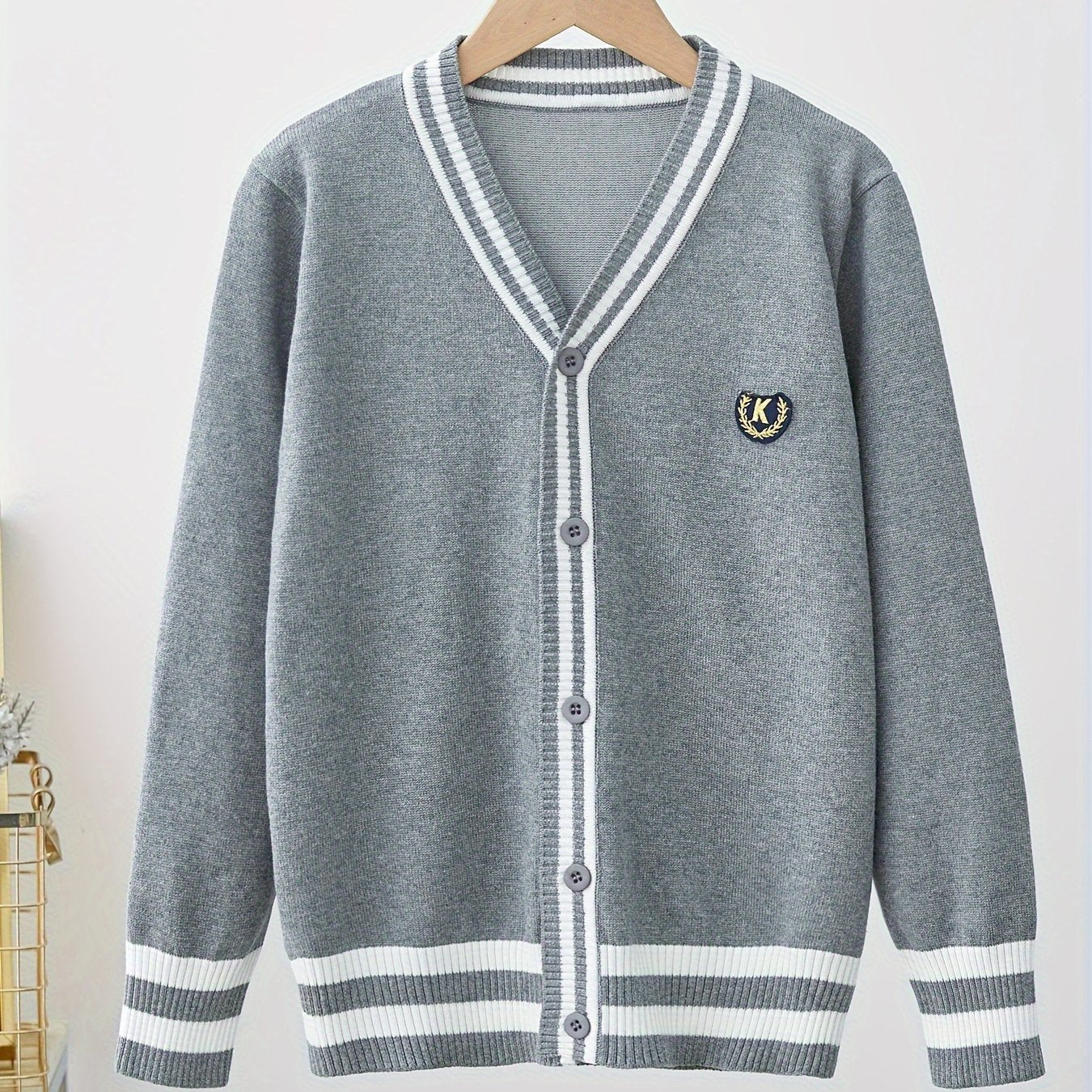 Youngsters' black and white striped V-neck cardigan with "K" logo, suitable for boys and girls in spring and fall. Perfect for school uniforms, stylish and versatile.