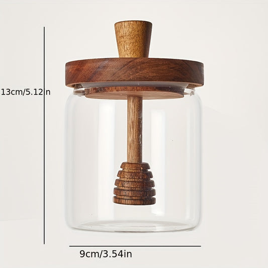 Premium honey jar with wooden stirring stick, made of high borosilicate glass for transparent honey storage.