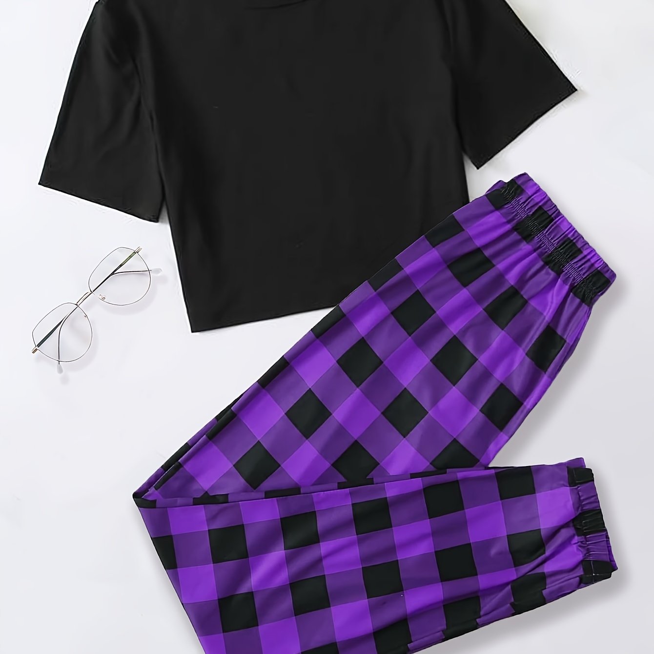 Plaid pajama set for women featuring a short sleeve top and elastic waistband pants.