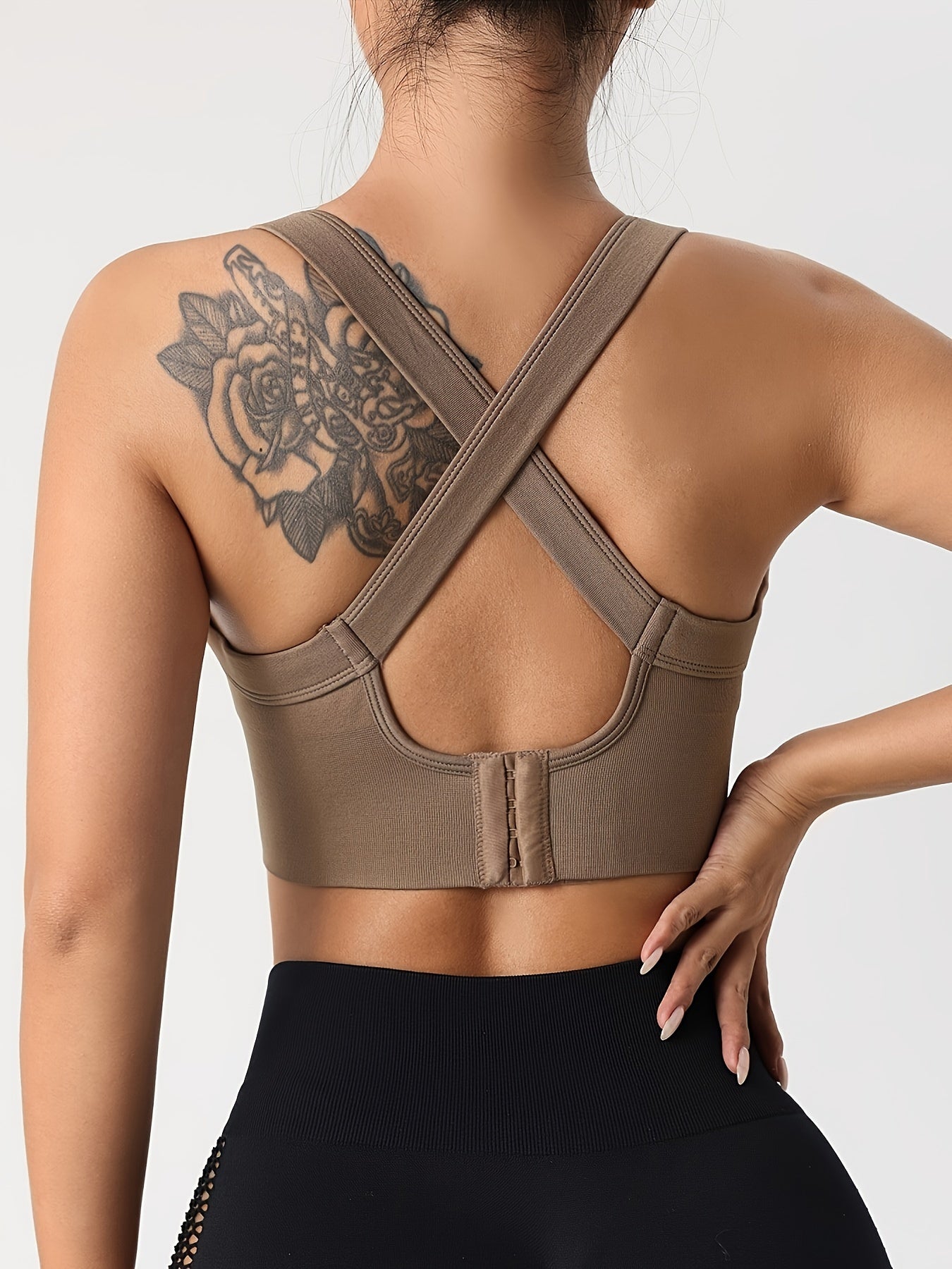 Solid color sports bra with halter neck and crisscross design, perfect for hot yoga and fitness.