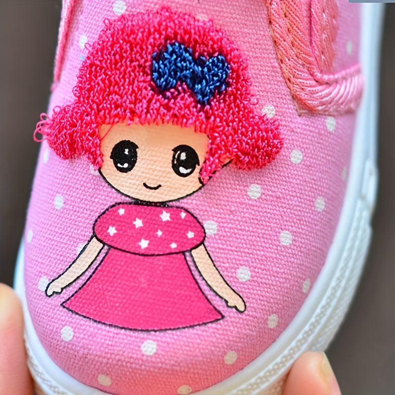 Adorable pink polka dot slip-on canvas shoes for girls featuring cute cartoon embroidery, breathable fabric, lightweight and comfortable for spring and fall. Durable TPR sole and easy