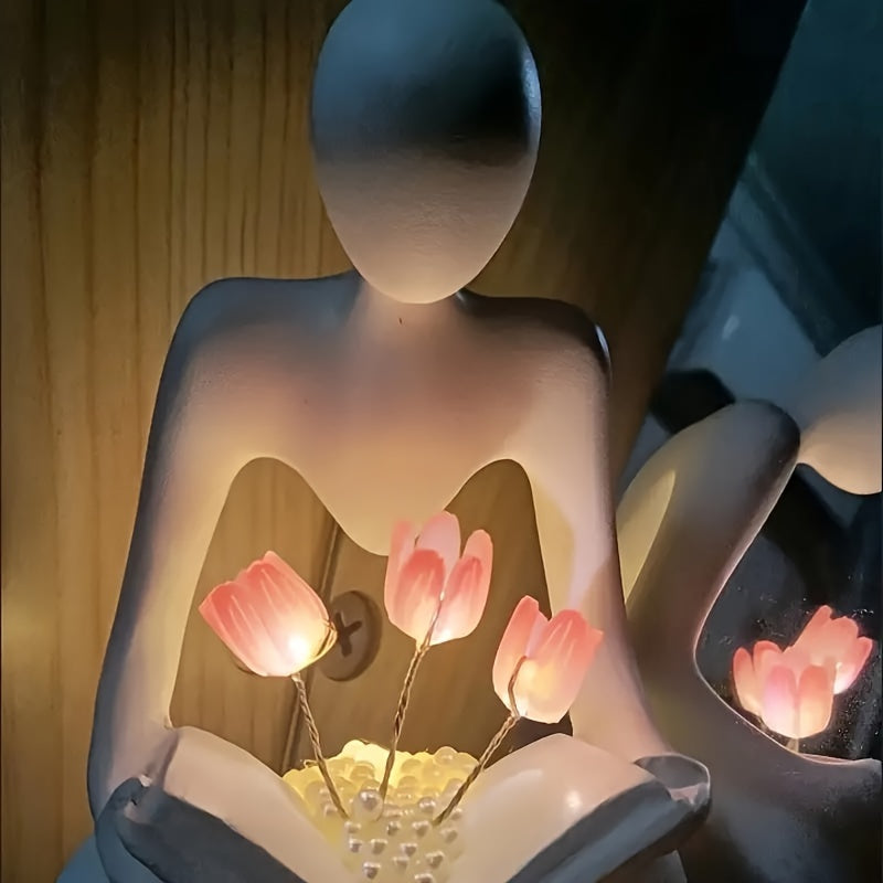 Modern abstract human figure & tulips LED night lamp with adjustable brightness. Ideal bedroom desk decor and birthday gift. Battery-powered with push button control.