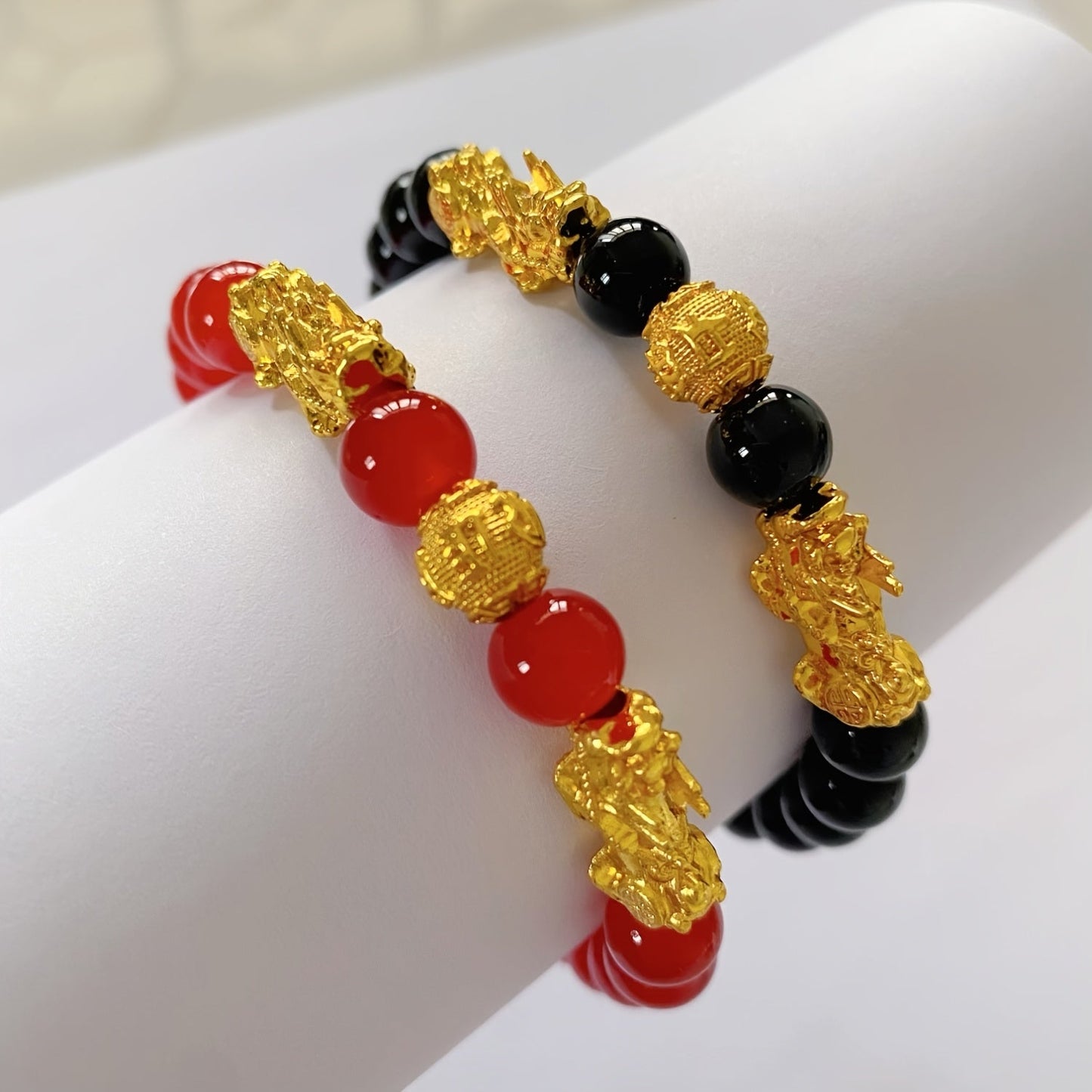 Two Pixiu bracelets, one in red antique style, offering a safe and lucky accessory. This classic, luxurious piece symbolizes prosperity and is beautifully crafted with shiny, artificial jewels. Perfect for gifting to girlfriends, sisters, or mothers to