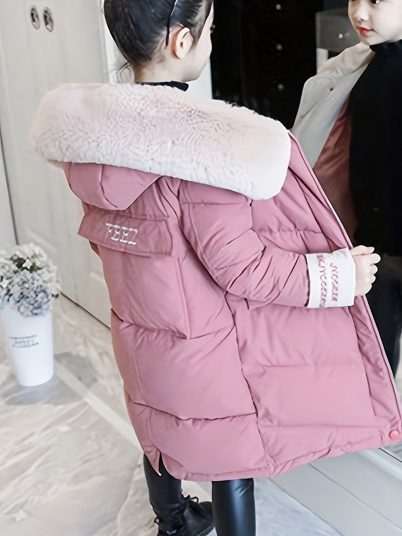 Stylish mid-length winter coat with faux fur hood for Korean fashion lovers. Made of 100% polyester and machine washable, with striped cuffs for added flair.