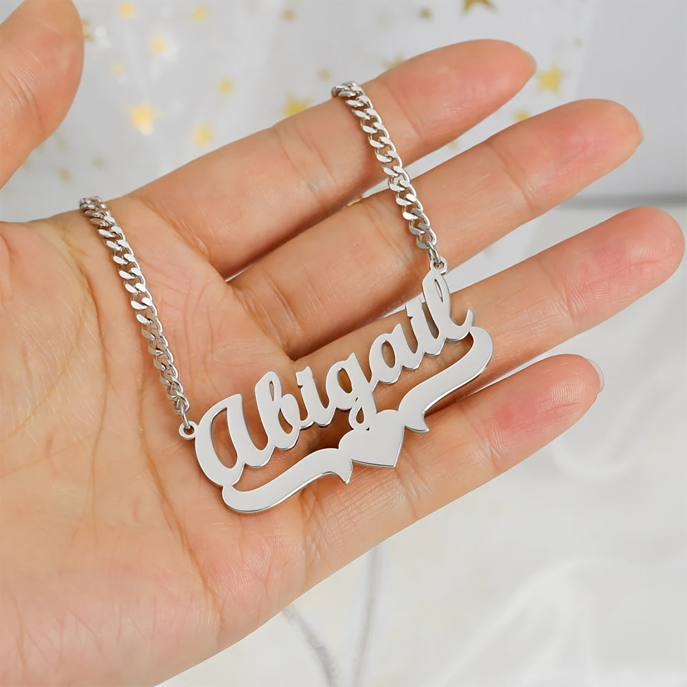 Adorn yourself with a unique 4mm Cuban link chain necklace featuring a personalized name pendant, crafted from elegant stainless steel with a heart ribbon design. This fashion jewelry for women is a versatile daily accessory that can be worn all year