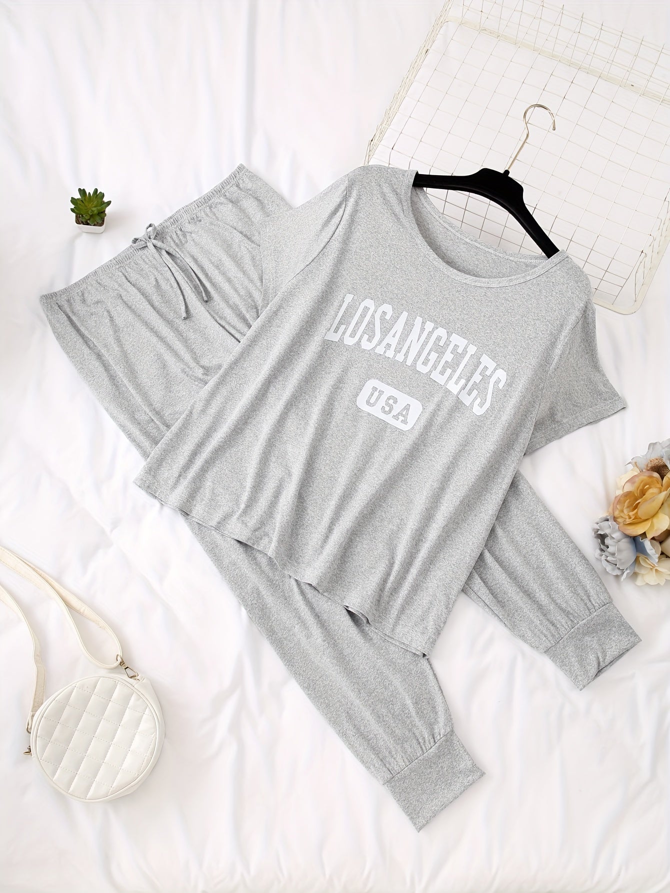 Women's casual pajama set with alphabet pattern, color block design, made of polyester knit fabric with elastane. Includes short sleeve top and long pants loungewear for fall season.