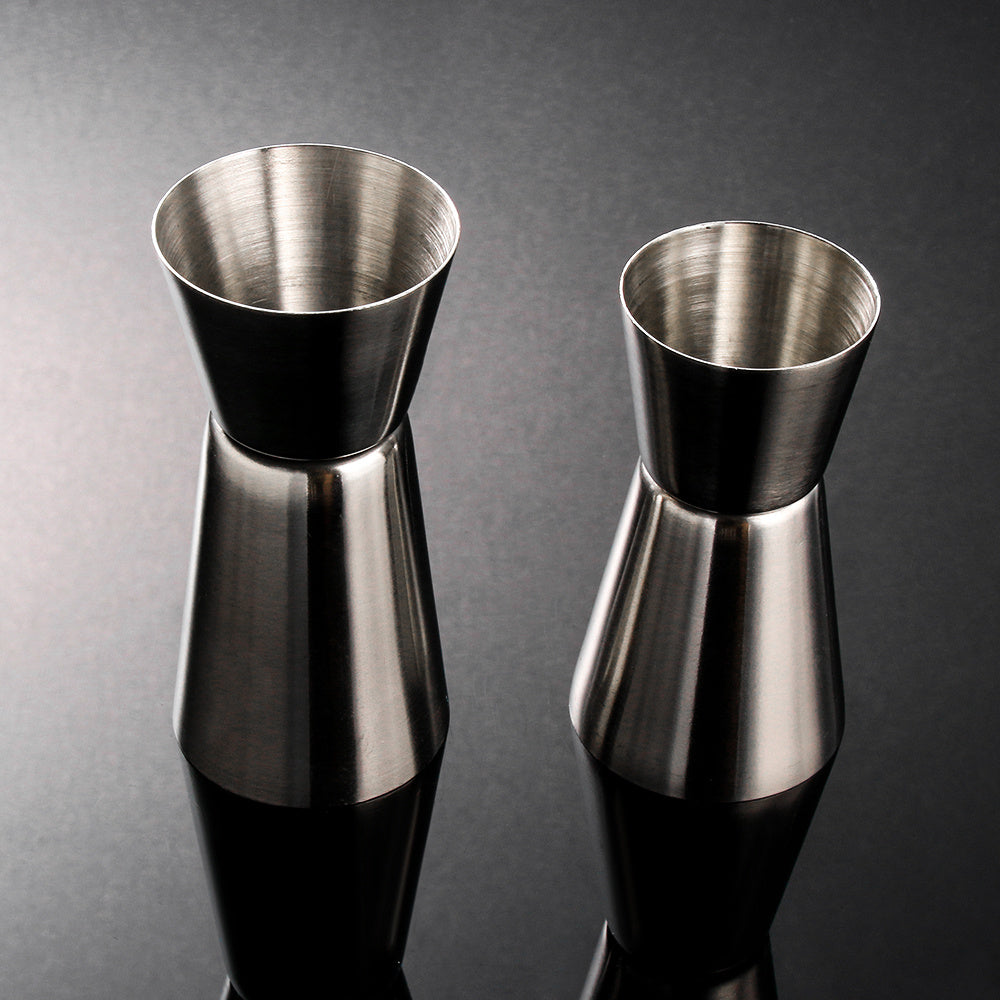 Stainless steel measuring cup, cocktail shaker, and jigger - perfect for bartending and kitchen use.