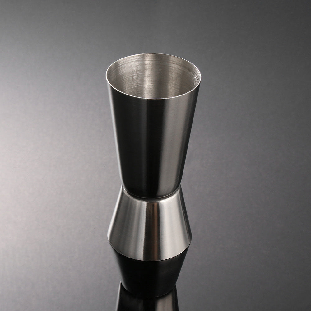 Stainless steel measuring cup, cocktail shaker, and jigger - perfect for bartending and kitchen use.