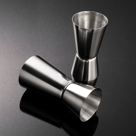 Stainless steel measuring cup, cocktail shaker, and jigger - perfect for bartending and kitchen use.