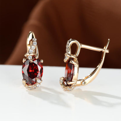 Trendy women's earrings featuring blue, white, red, and pink stones in round and oval cuts. These anniversary claw earrings are plated with 18K gold. Perfect for adding a pop of color to any outfit.