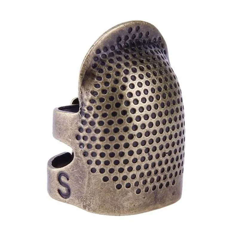 Vintage metal thimble for needlework and crafting.