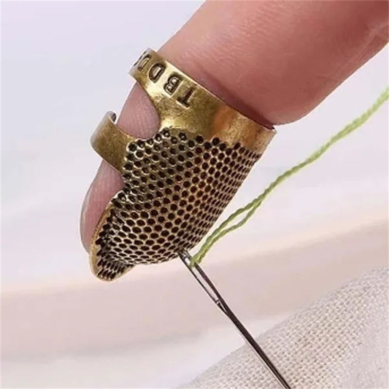 Vintage metal thimble for needlework and crafting.