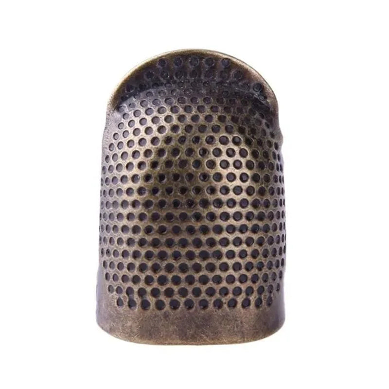 Vintage metal thimble for needlework and crafting.