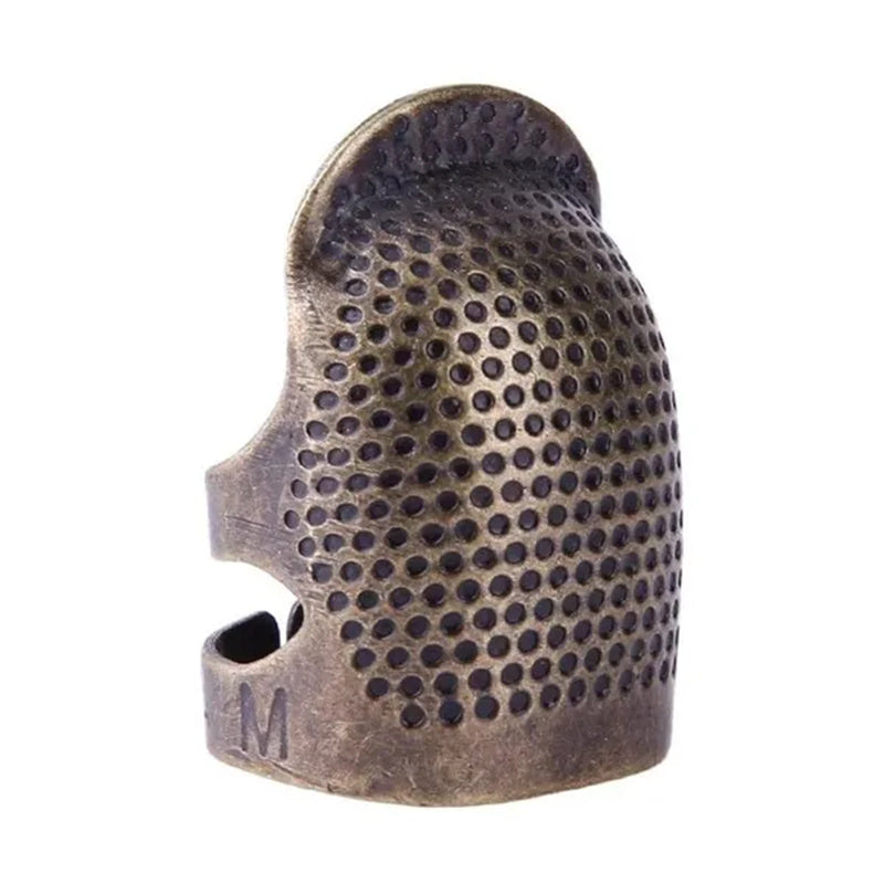 Vintage metal thimble for needlework and crafting.