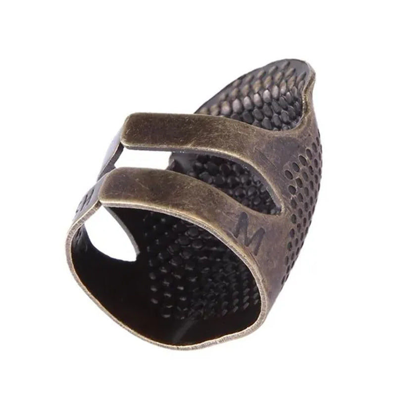 Vintage metal thimble for needlework and crafting.