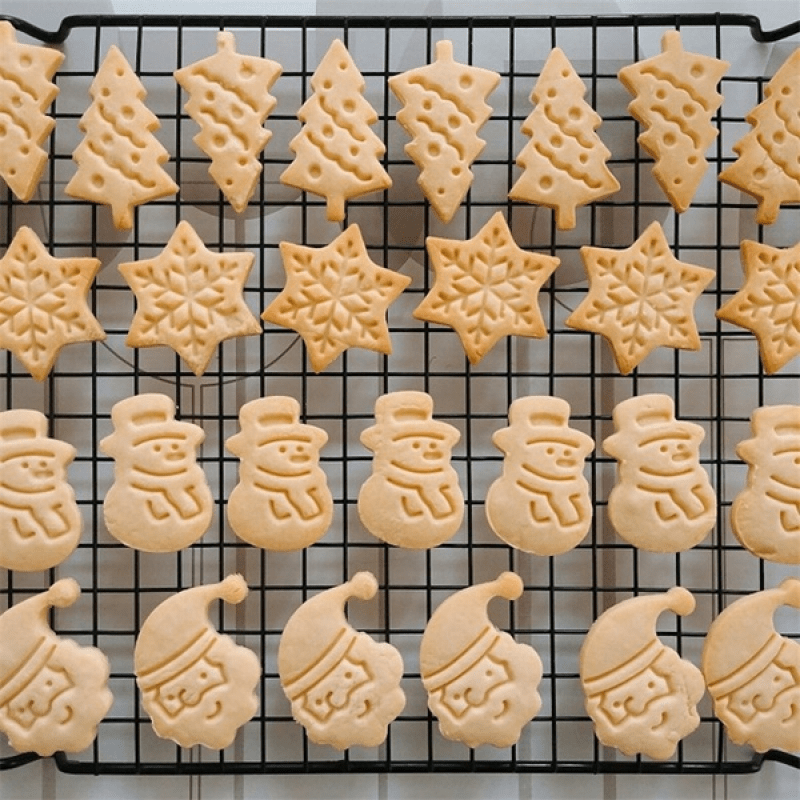 Christmas Cookie Cutter Set includes 4 pieces featuring Snowman, Snowflake, Christmas Tree, and Santa Claus patterns. Ideal for holiday baking.