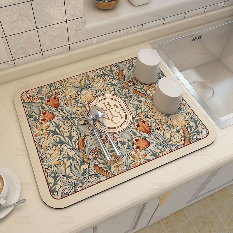 Fabric dish drying mat in a fantasy style, made of diatom mud for efficient draining. This versatile pad is perfect for drying bowls and plates, and can also be used as a washable water absorption pad for bar tables. It provides heat insulation, tabletop