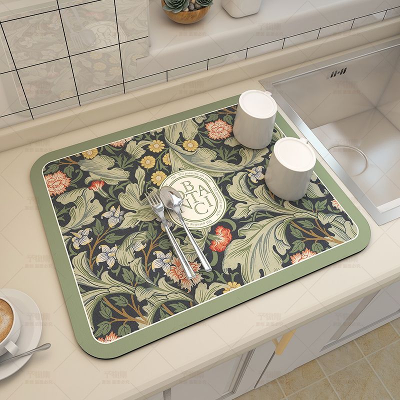 Fabric dish drying mat in a fantasy style, made of diatom mud for efficient draining. This versatile pad is perfect for drying bowls and plates, and can also be used as a washable water absorption pad for bar tables. It provides heat insulation, tabletop