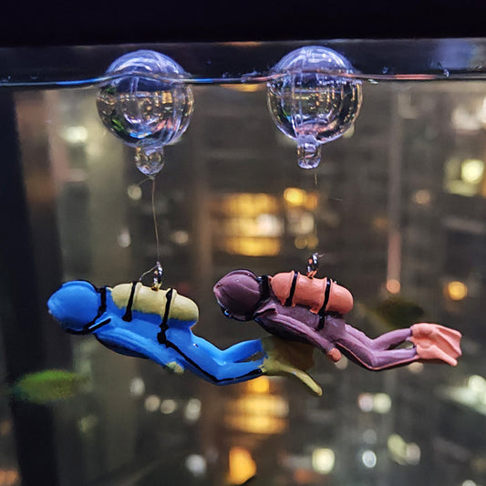 Colorful diver aquarium ornament adds vibrancy to underwater landscaping.