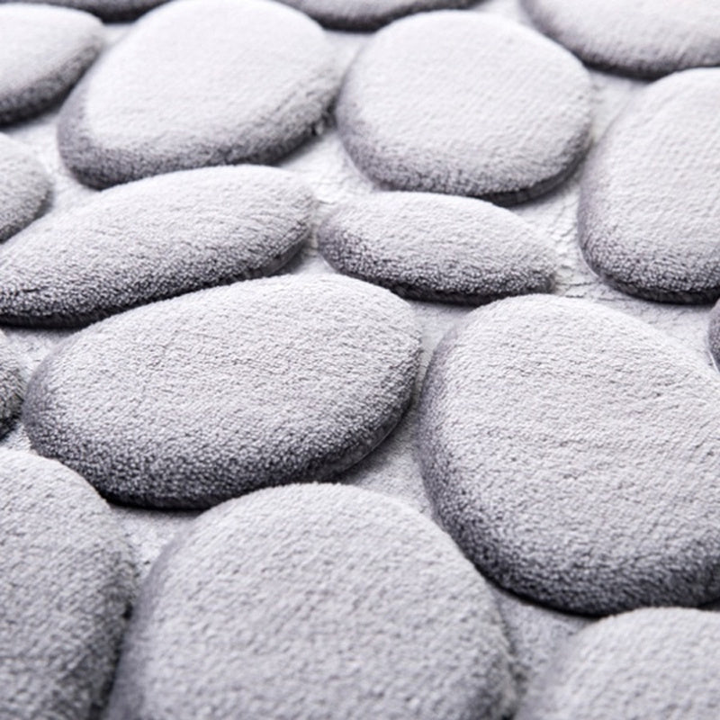 Soft, non-slip cobblestone bath rug absorbs water quickly for various indoor uses.