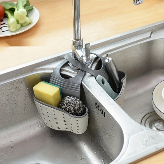 Space-saving kitchen sink organizer with perforated drain basket for sponges, cloths, and accessories. This durable hanging storage solution comes in a stylish light green and gray color scheme, perfect for home use. Ideal for keeping your kitchen sink