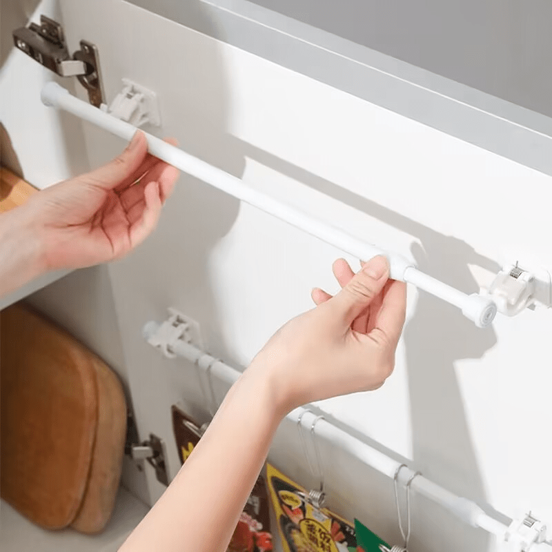 Versatile no-drill curtain rod in white plastic. Ideal for shower and window dressing. Minimalist and durable tension rod.