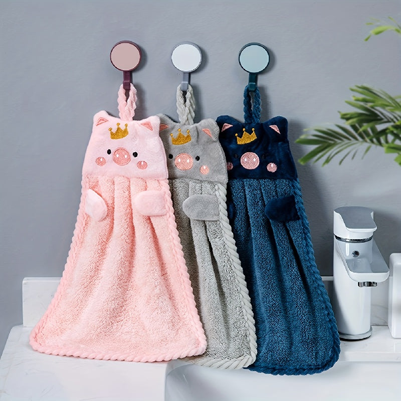 2 cute piggy hand towels made of super absorbent coral velvet with crown design. Includes hanging suction cups for easy display. Fun and whimsical bathroom or kitchen decor.