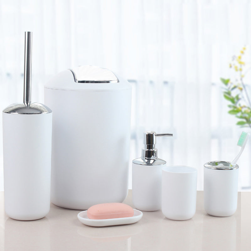 Plastic bathroom accessory set includes soap dispenser, toothbrush holder, toilet brush, trash can, tumbler, and soap dish.